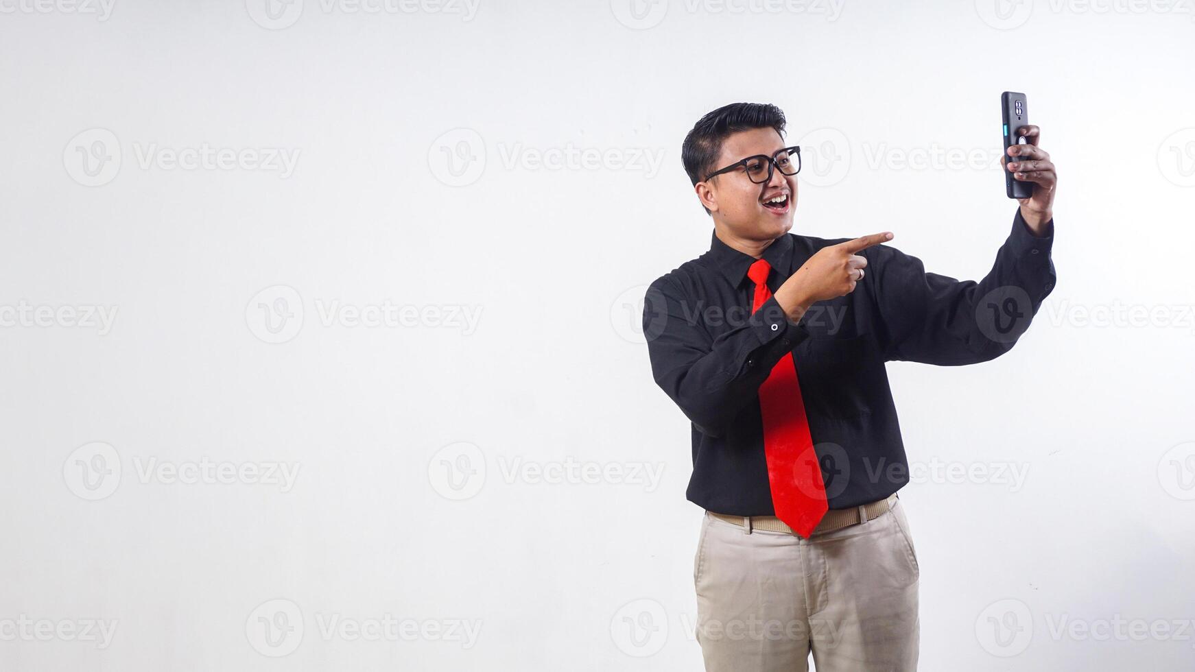 Happy Asian employee business man corporate wearing formal clothes pointing finger on mobile cell phone isolated on white background photo
