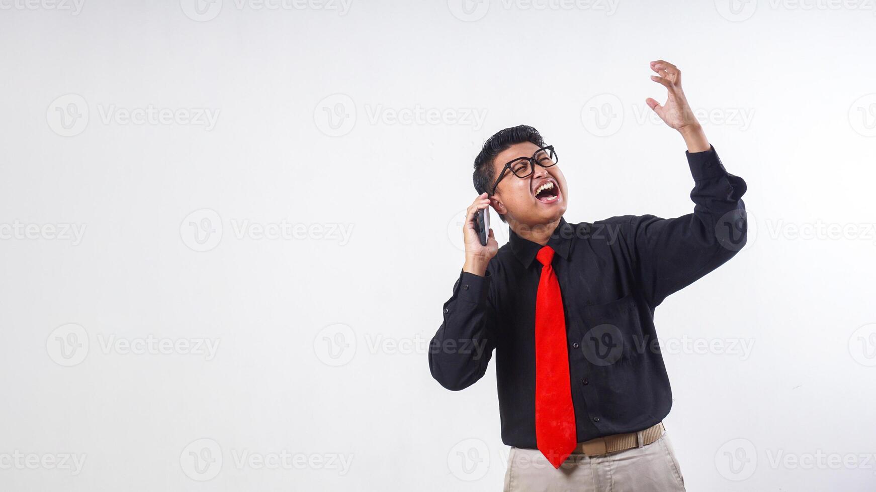 Portrait of Asian employee business man corporate wearing formal clothes talking on the mobile phone call with frustrated facial expression isolated on white background photo