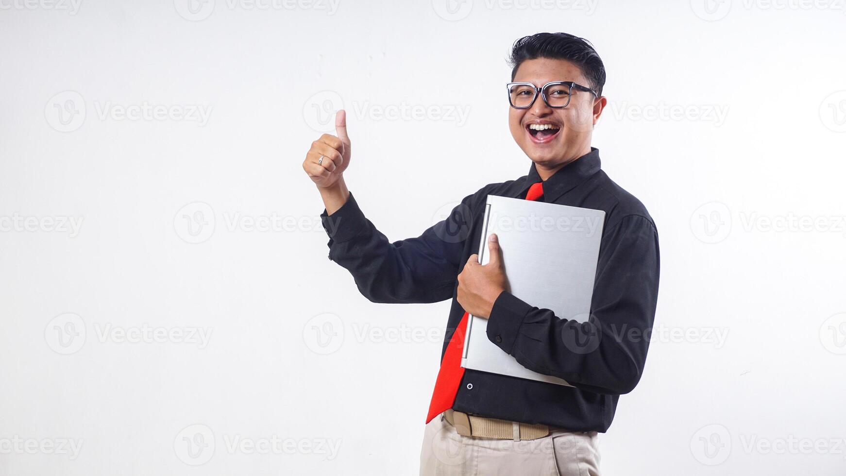 Excited Asian employee businessman corporate wearing formal clothes holding laptop and showing thumb up isolated on white background photo