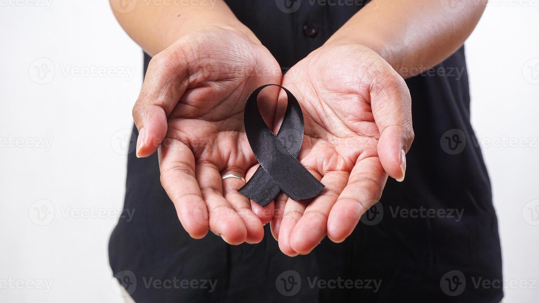Black ribbon in man hands isolated on white background photo