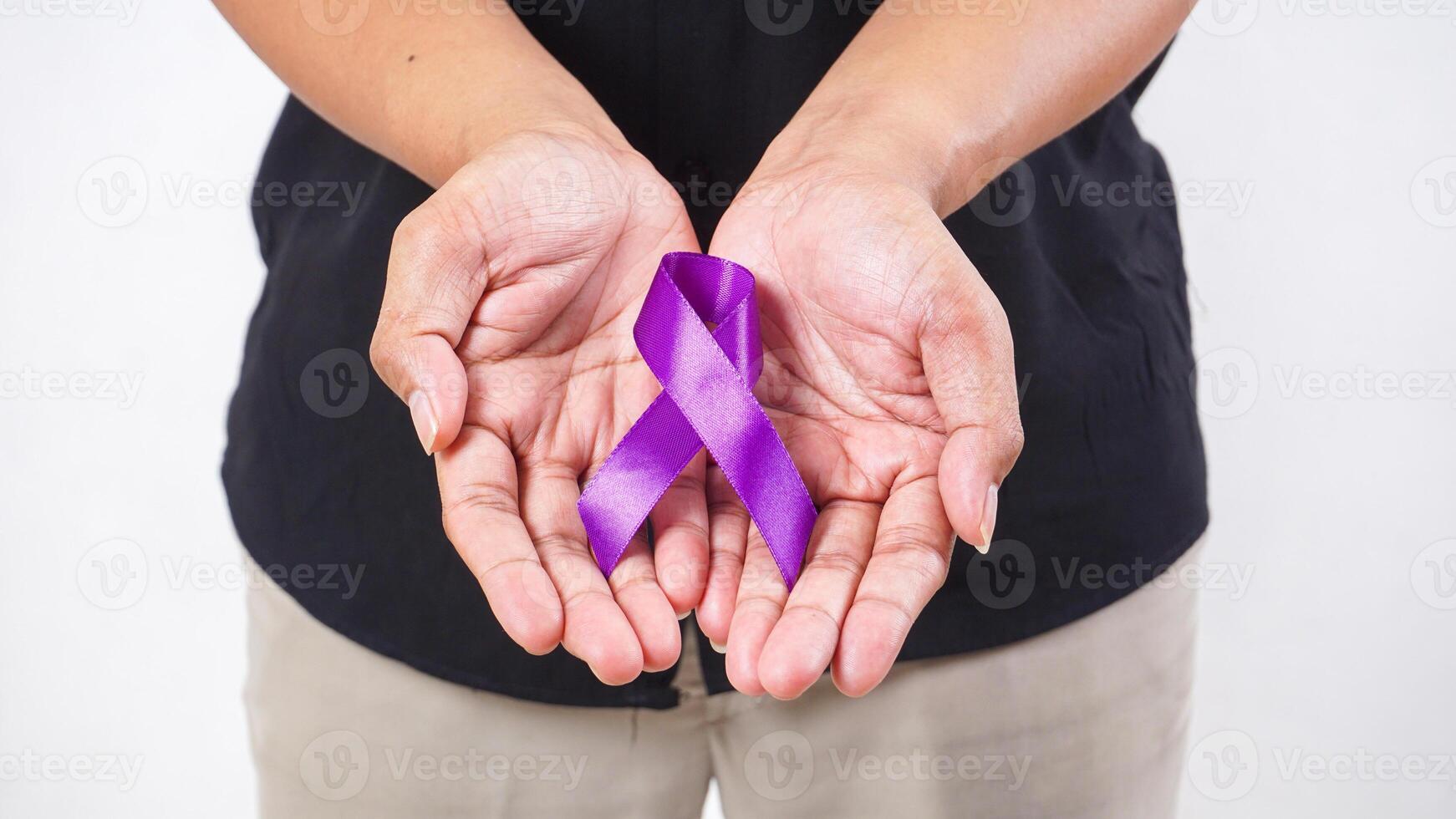 Hands showing purple ribbon on palm on white background photo