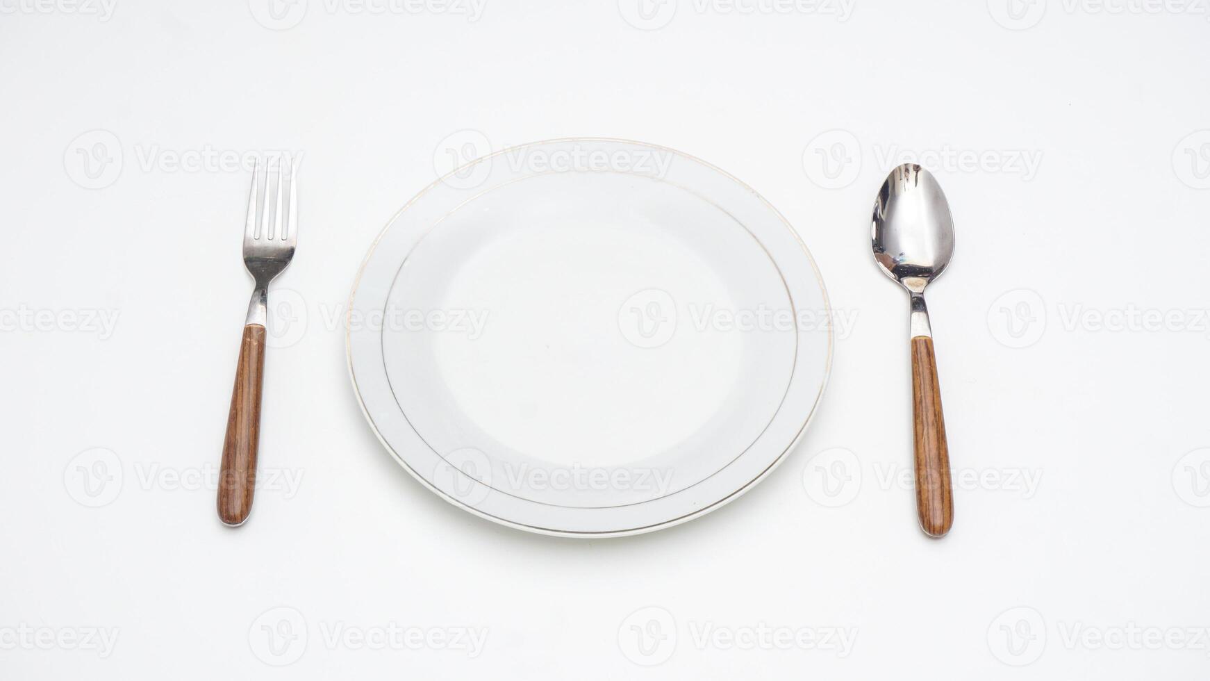 Wooden Handle Spoon, Fork, and Plate Isolated on White Background photo