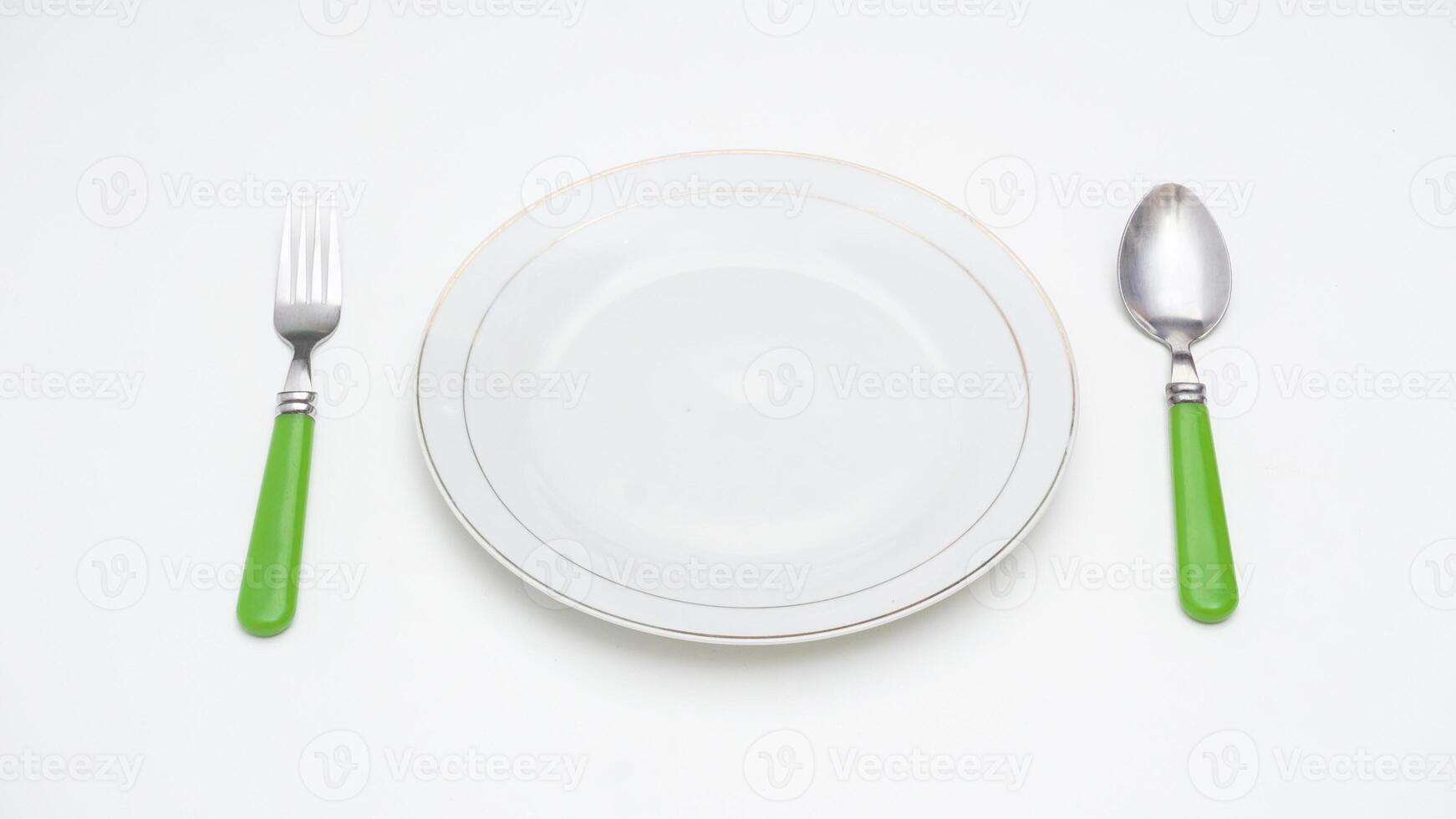 Classic Spoon, Fork, and Plate Isolated on White Background photo