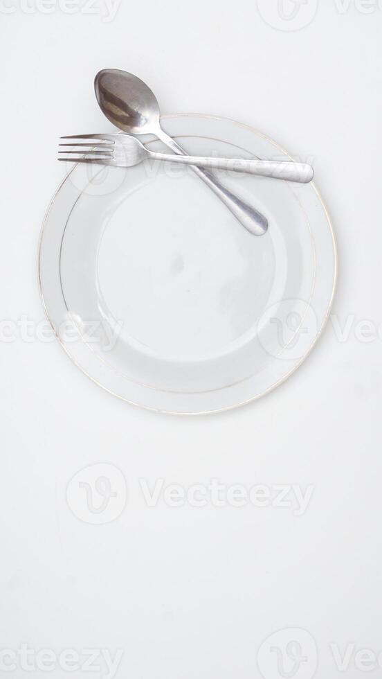 Spoon, Fork, and Plate of Tableware Set Isolated on White Background photo