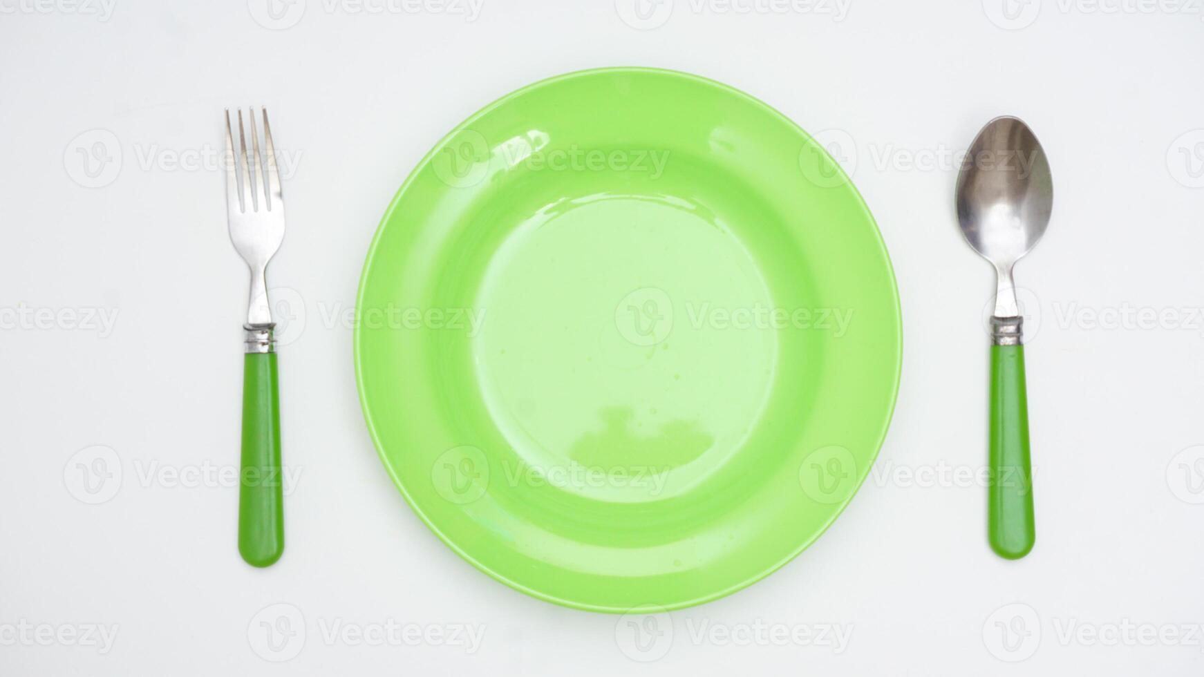 Simple Spoon, Fork, and Plate Isolated on White Background photo