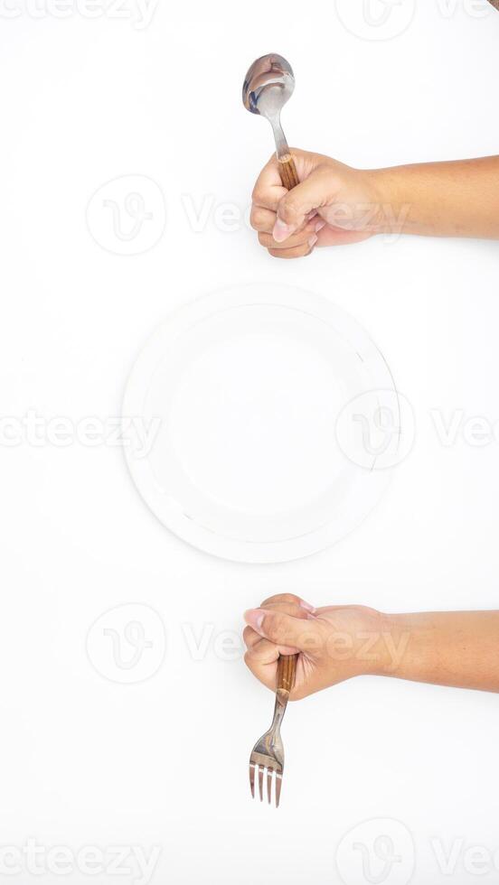Hand with Silverware and Plate Isolated on White Background photo