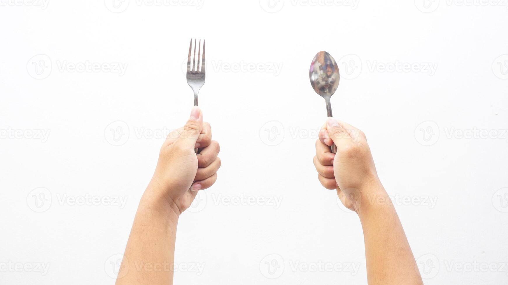 Hands Holding Spoon and Fork Isolated on White Background photo