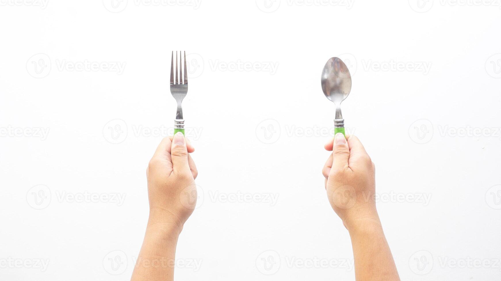 Hands of Man Holding Silver Stainless Spoon and Fork Isolated on White Background photo