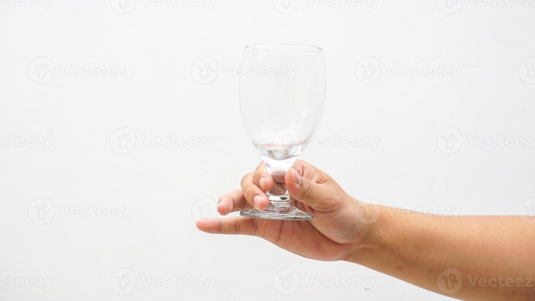 Hand of Man Holding Beautiful Glass Isolated on White Background photo
