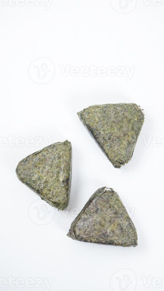 Top view of Japanese onigiri made from savory rice in triangular shaped wrapped in nori or seaweed isolated on white background photo