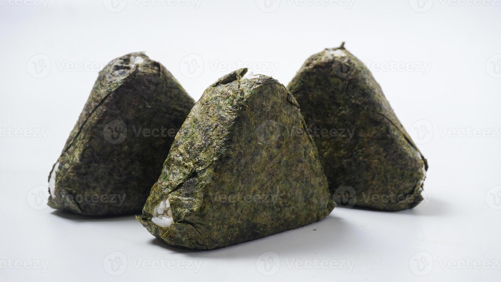 Three delicious onigiri or Japanese rice ball wrapped in nori dried seaweed on isolated on white background photo