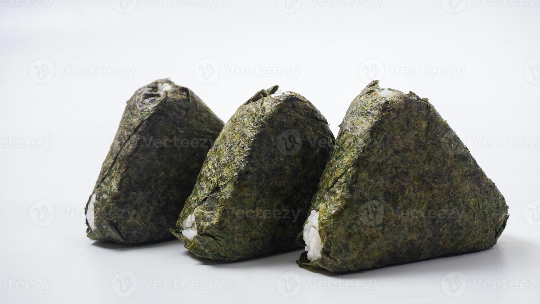 Three delicious onigiri or Japanese savory rice ball wrapped in nori dried seaweed on isolated on white background photo
