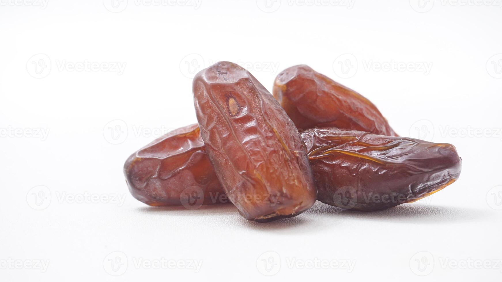 Sweet Dried Dates Fruit for Ramadan Iftar Nutritious Snack Isolated on White Background photo