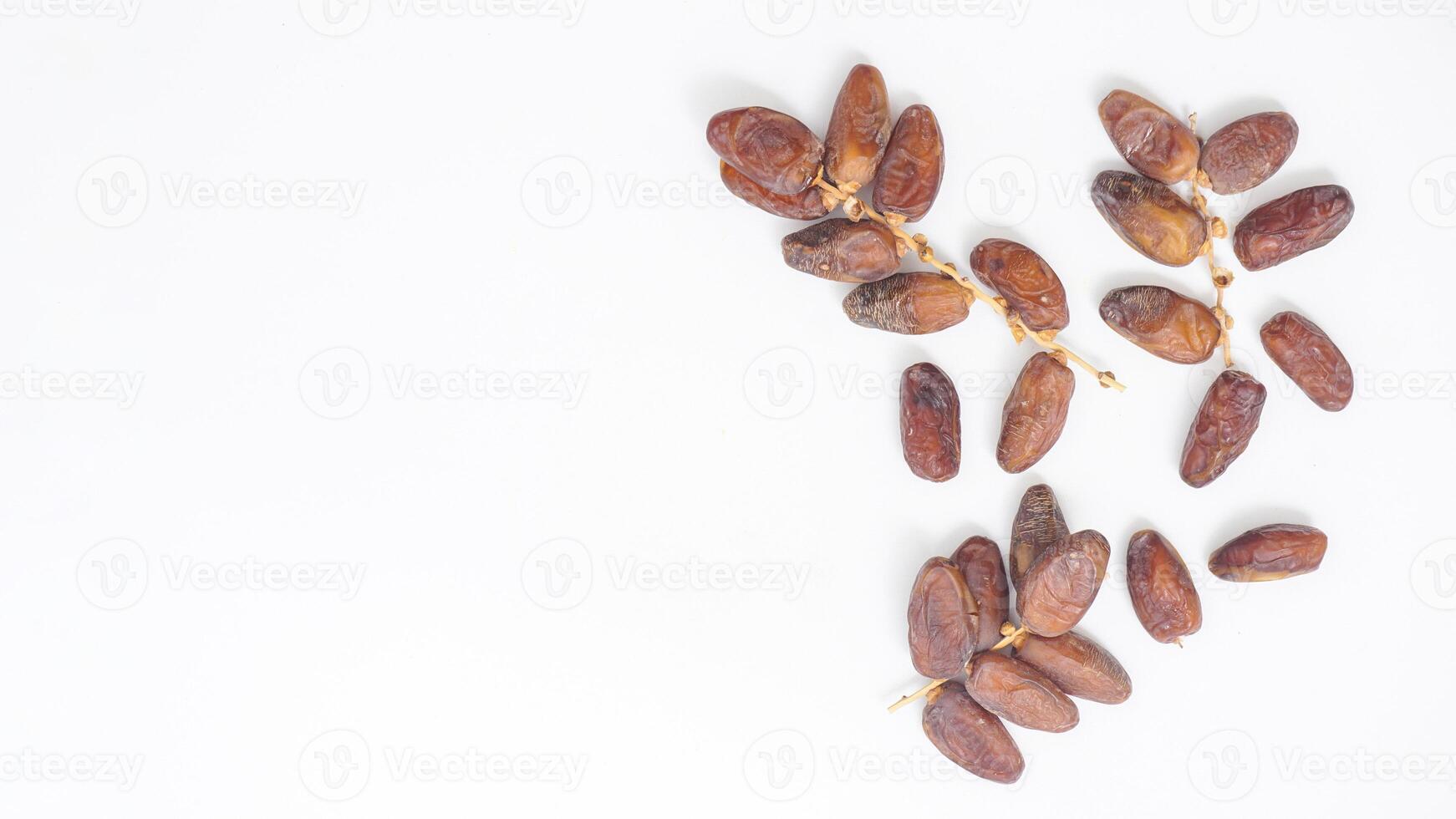 Delicious Ripe Dried Dates Fruit on Stalk Ramadan Fasting Isolated on White Background photo