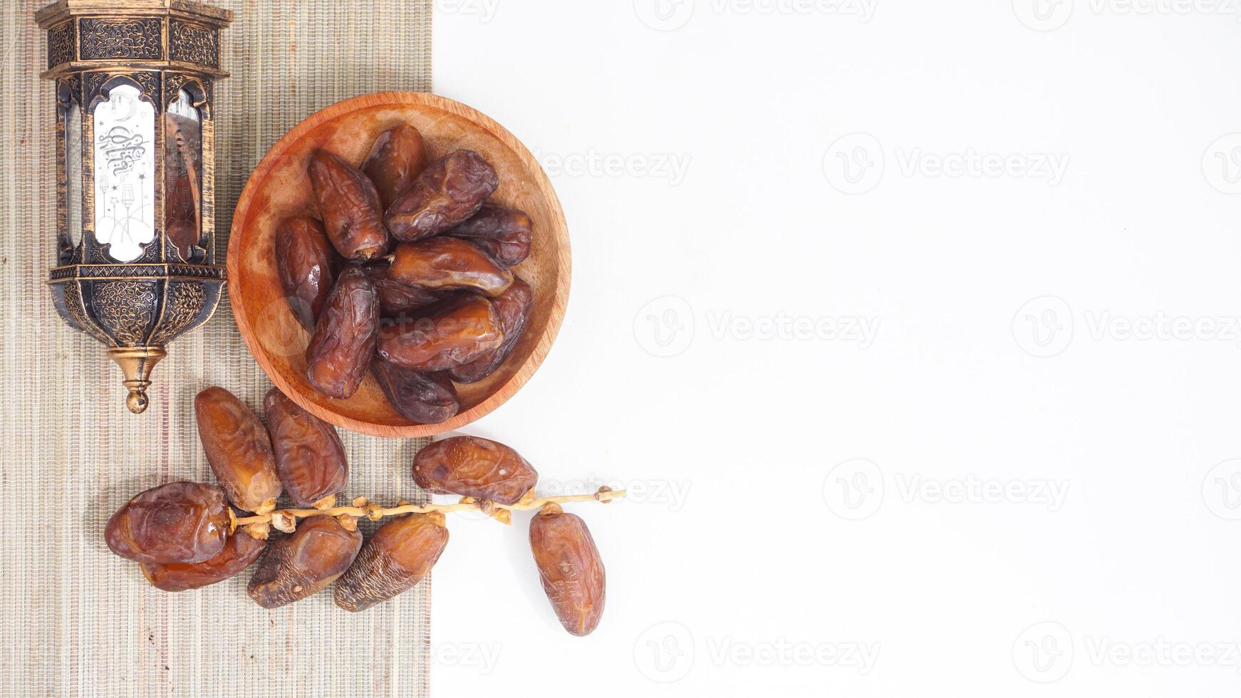 Dried Dates Fruit on Wooden Plate for Ramadan Nutritious Snack Isolated on White Background photo