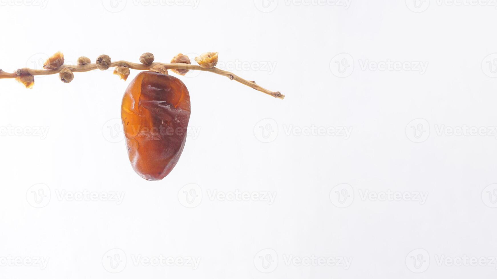 Golden Brown Dates Fruit on It Stalk Isolated on White Background photo