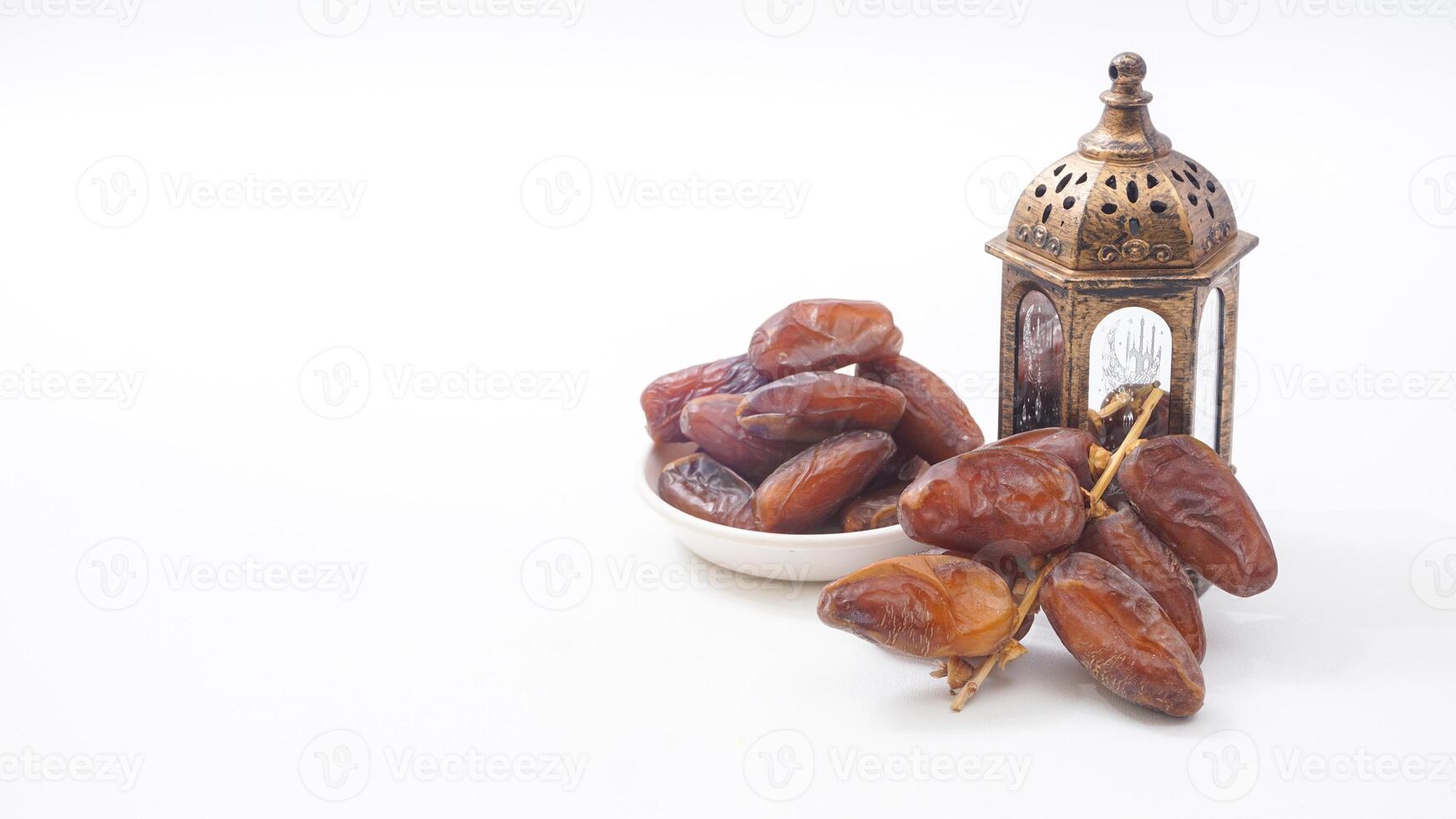 Dry Dates Fruit on Bowl for Ramadan Iftar with Islamic Lantern Isolated on White Background photo