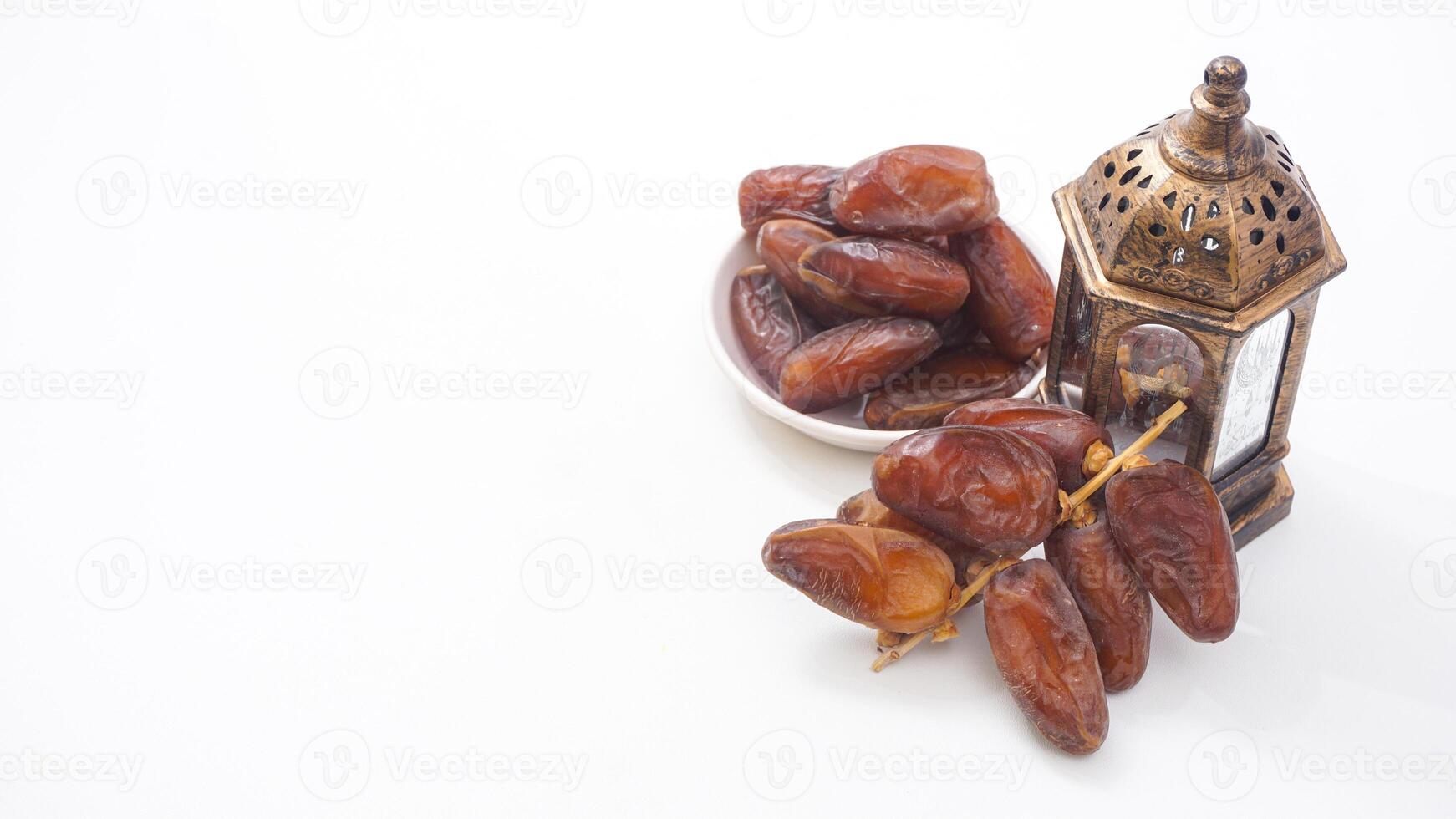 A Bowl of Sweet Dates Fruit Perfect for Iftar Isolated on White Background photo