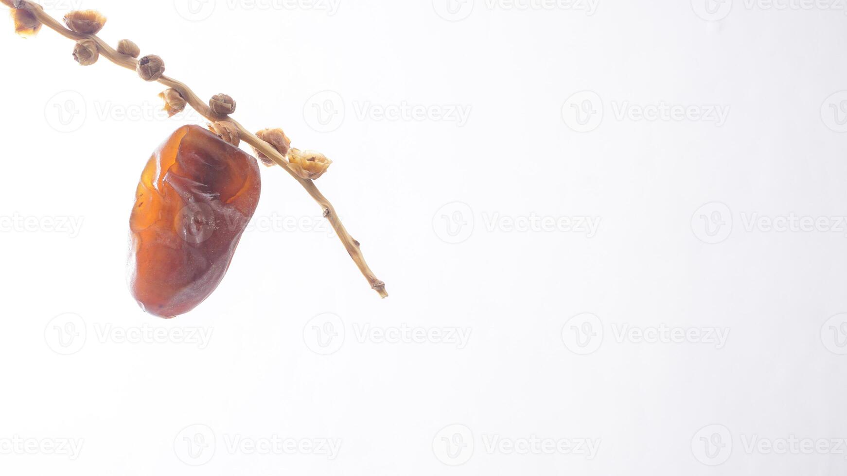 Sweet Golden Brown Dates Fruit on It Stalk Isolated on White Background photo