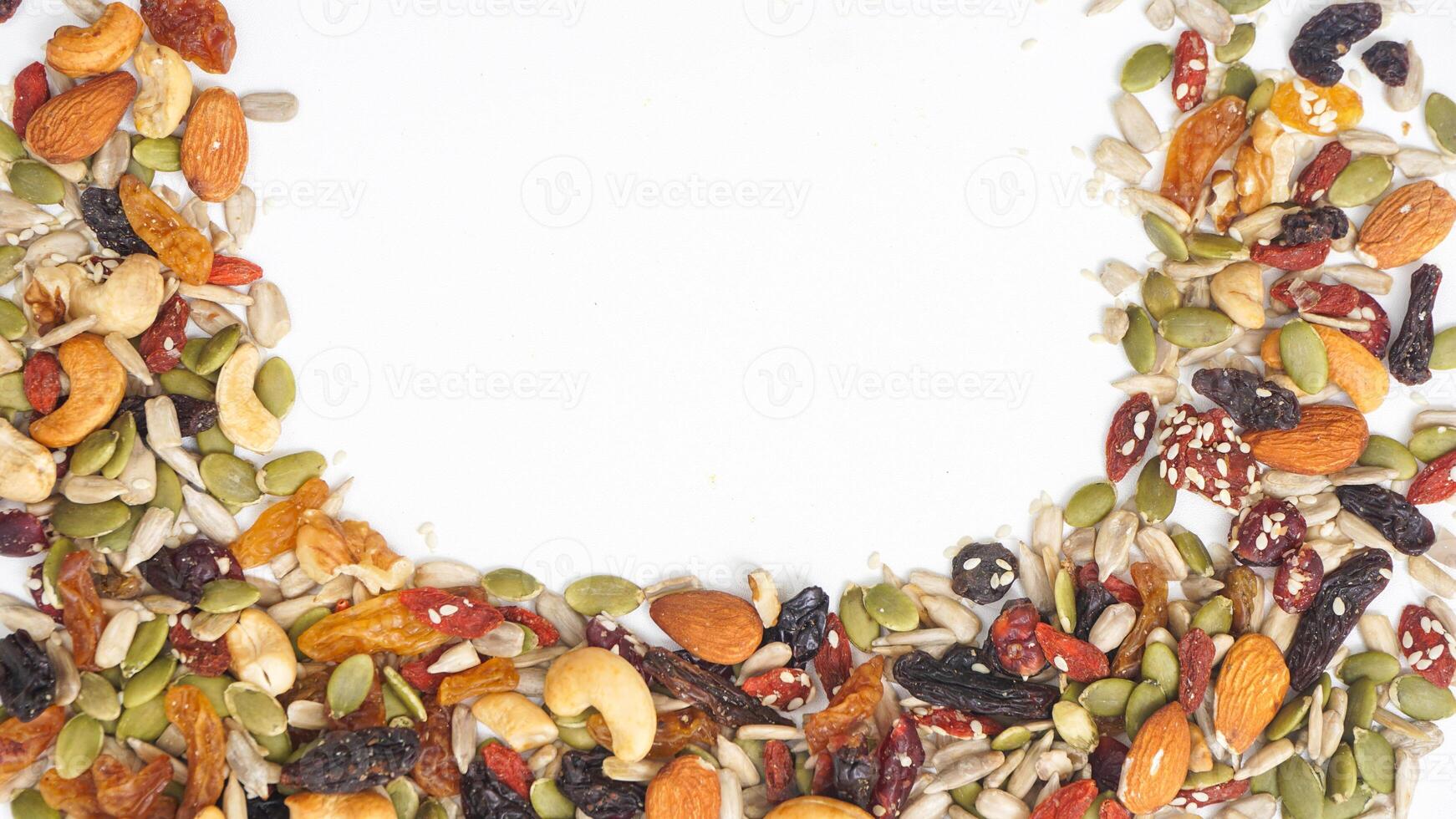 Assorted crunchy nuts seeds and dried fruits isolated on white background photo