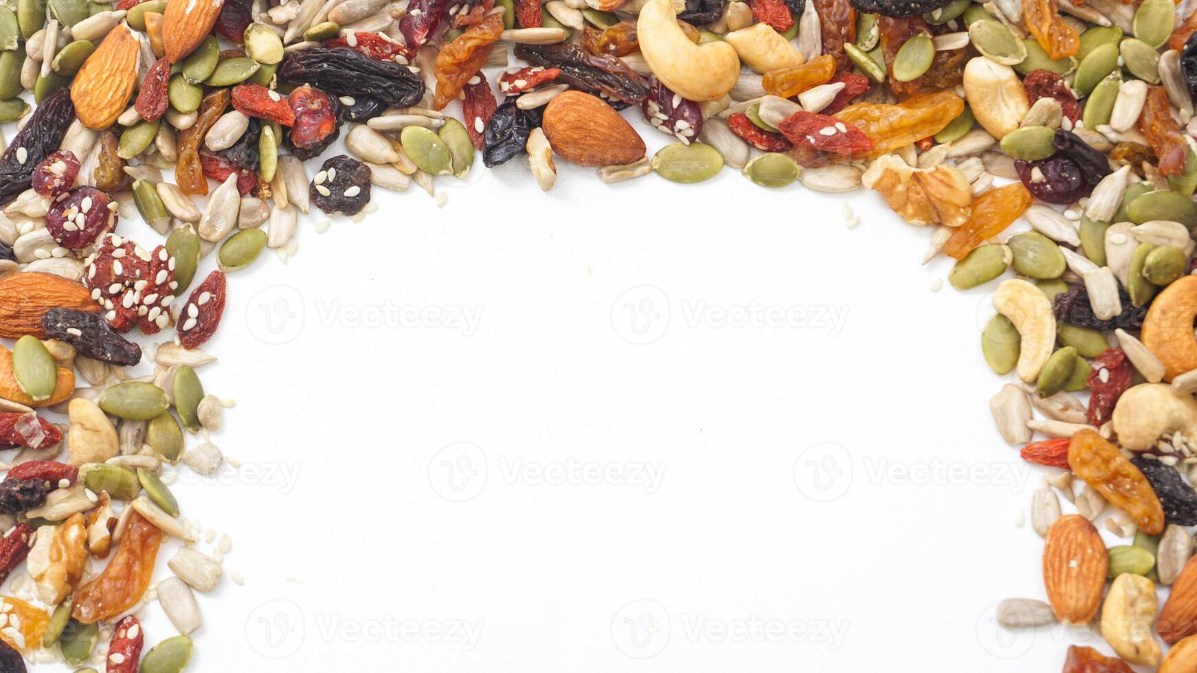Organic nuts seeds and dried fruits mixture isolated on white background photo