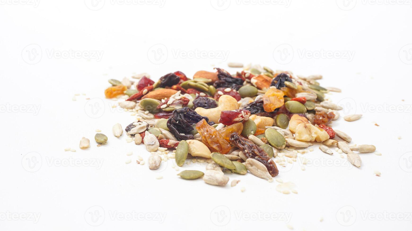 Crunchy nuts seeds and dried fruits assortment isolated on white background photo