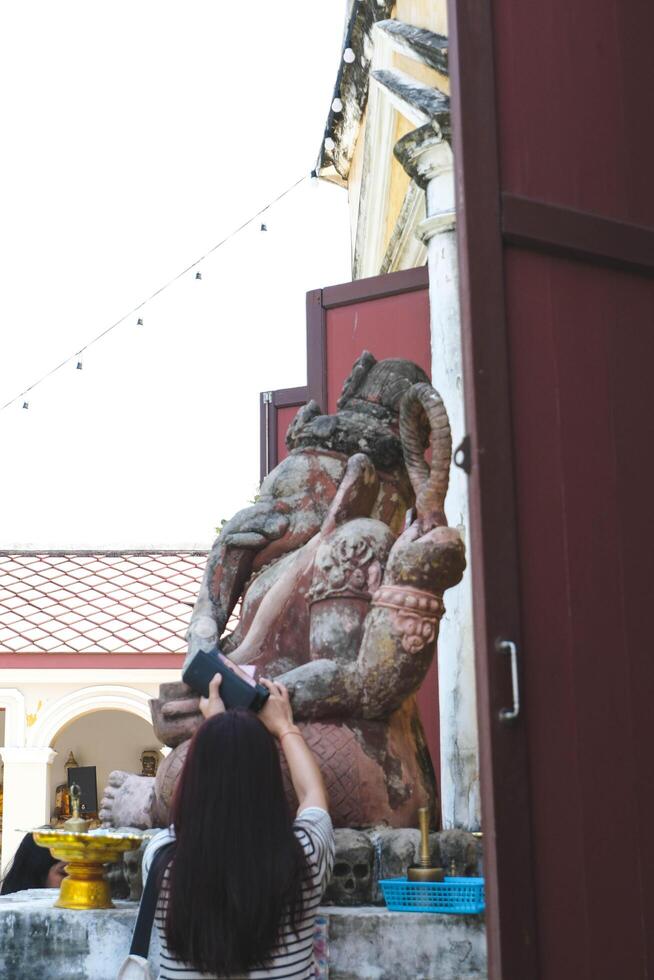 People worshiping Lord Ganesha at Nakhon Luang Palace, Ayutthaya, Thailand photo