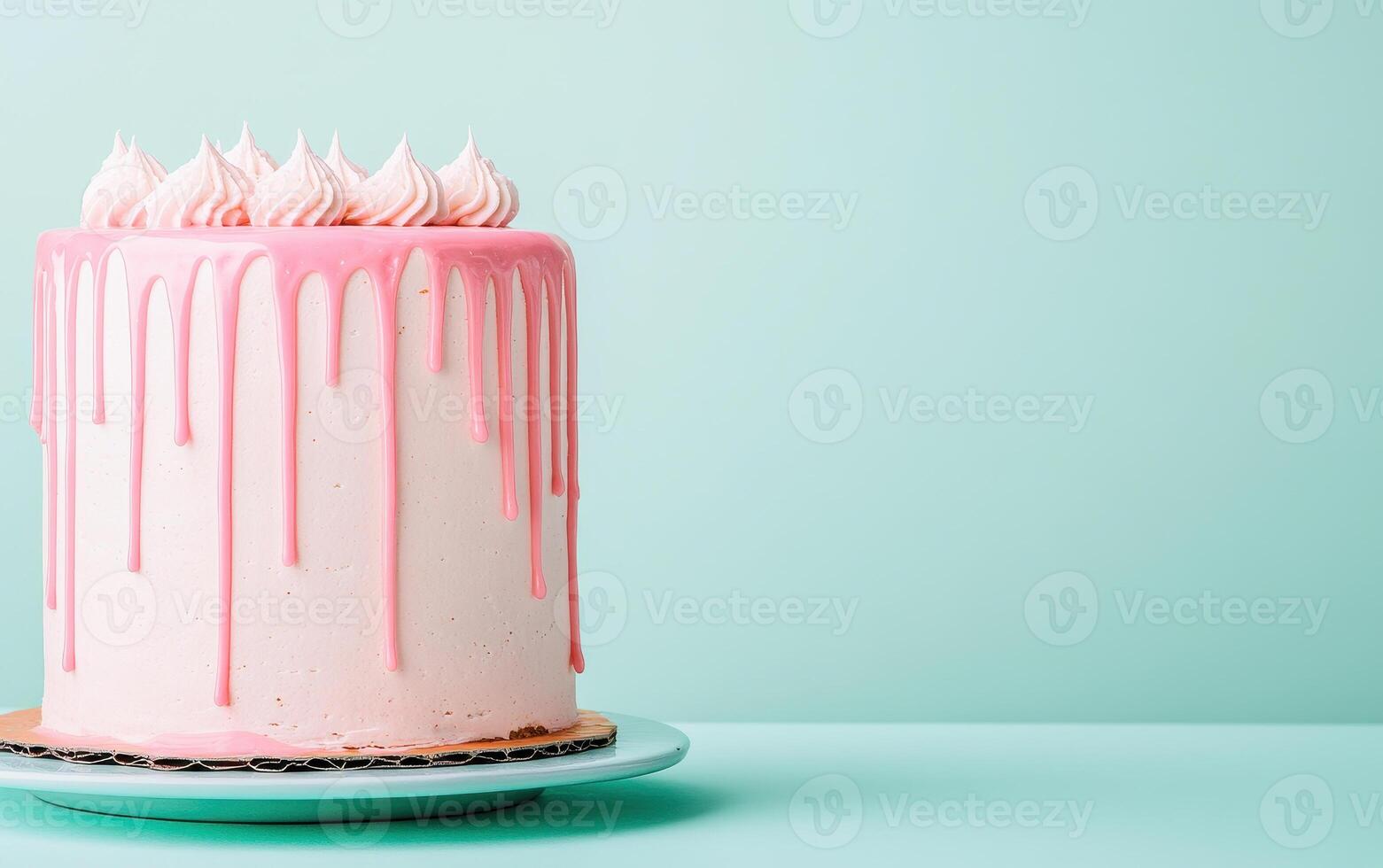 Delicious homemade cake with pink dripping glaze, beautifully presented against mint green background, perfect for celebrations and special occasions photo