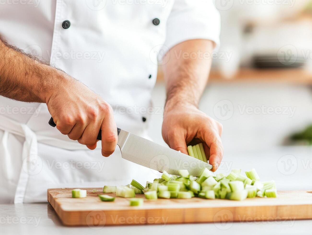Chef chopping celery sticks on wooden cutting board, showcasing culinary skills and fresh ingredients. vibrant green celery adds pop of color to kitchen scene photo