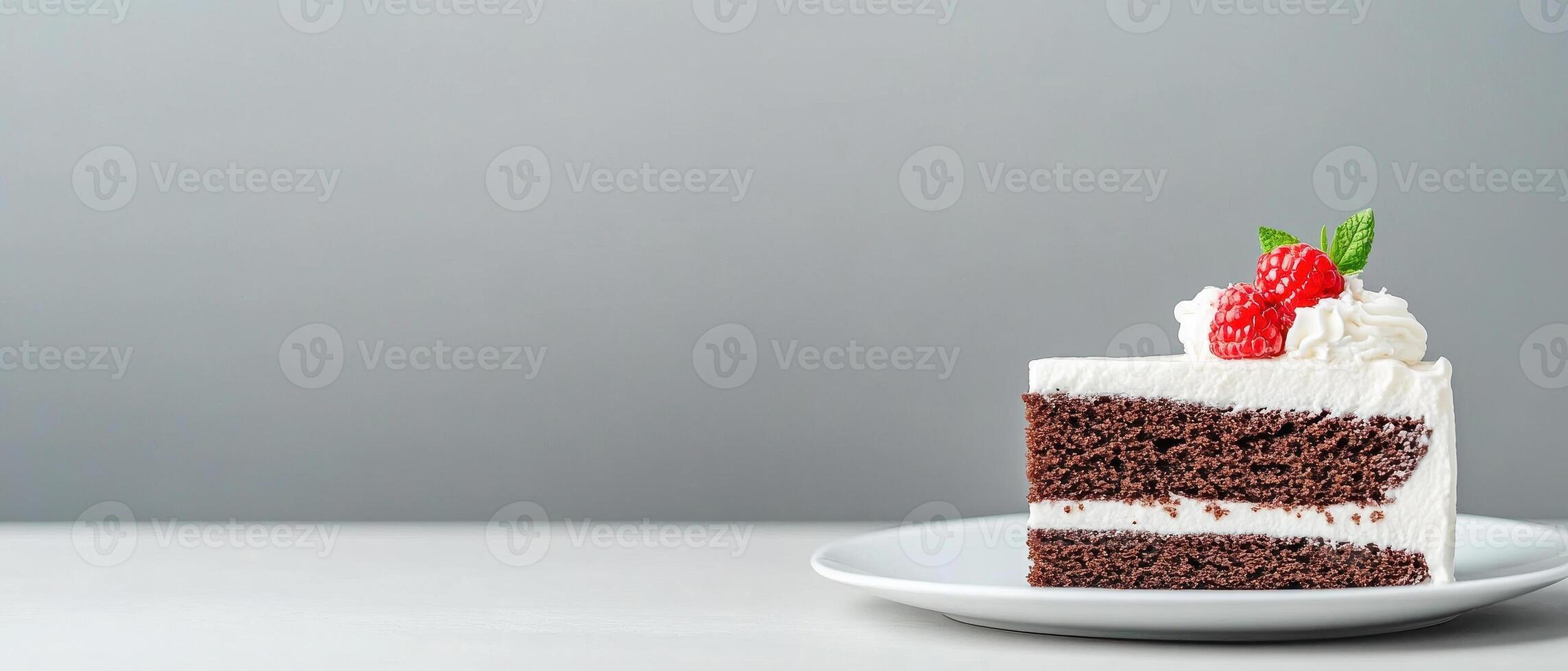 Delicious homemade cake slice on elegant plate, featuring layers of chocolate and cream, topped with fresh raspberries and mint leaves, perfect for dessert lovers photo