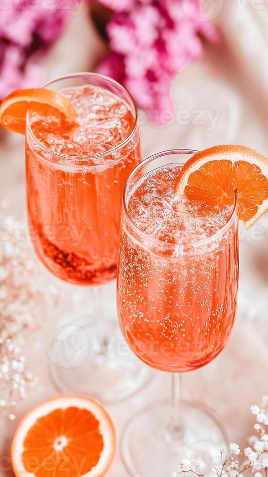 Refreshing summer drinks in clear glass cups with fresh citrus slices. vibrant colors and bubbles create joyful atmosphere, perfect for warm days photo