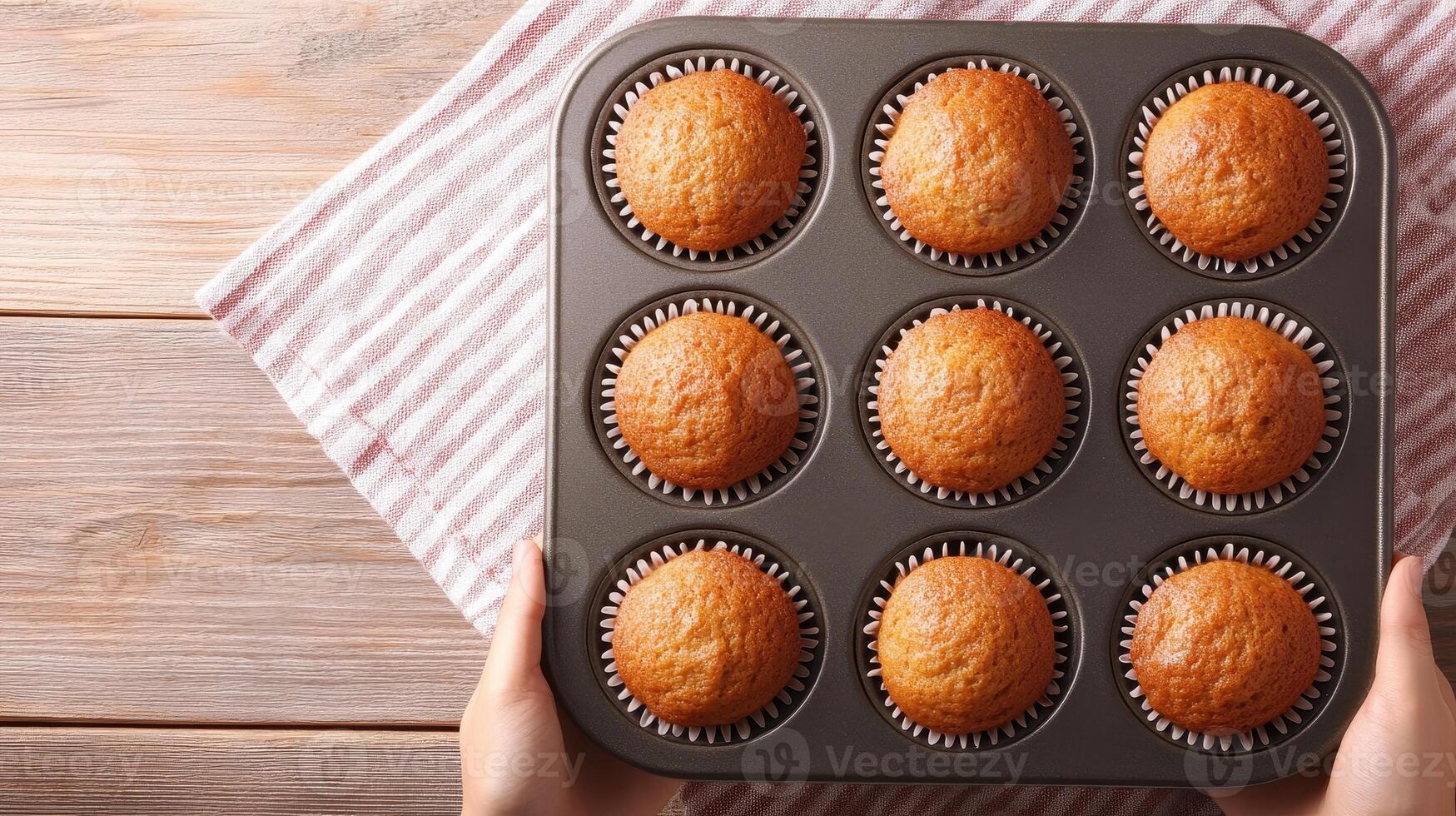 Freshly baked homemade muffins in baking tray, golden brown and fluffy, ready to be enjoyed. Perfect for breakfast or snack photo