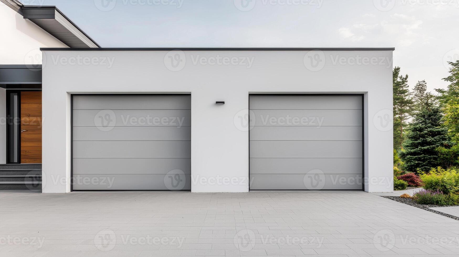 Modern garage with sleek design and clean driveway, featuring two spacious doors and minimalist aesthetic, surrounded by greenery photo