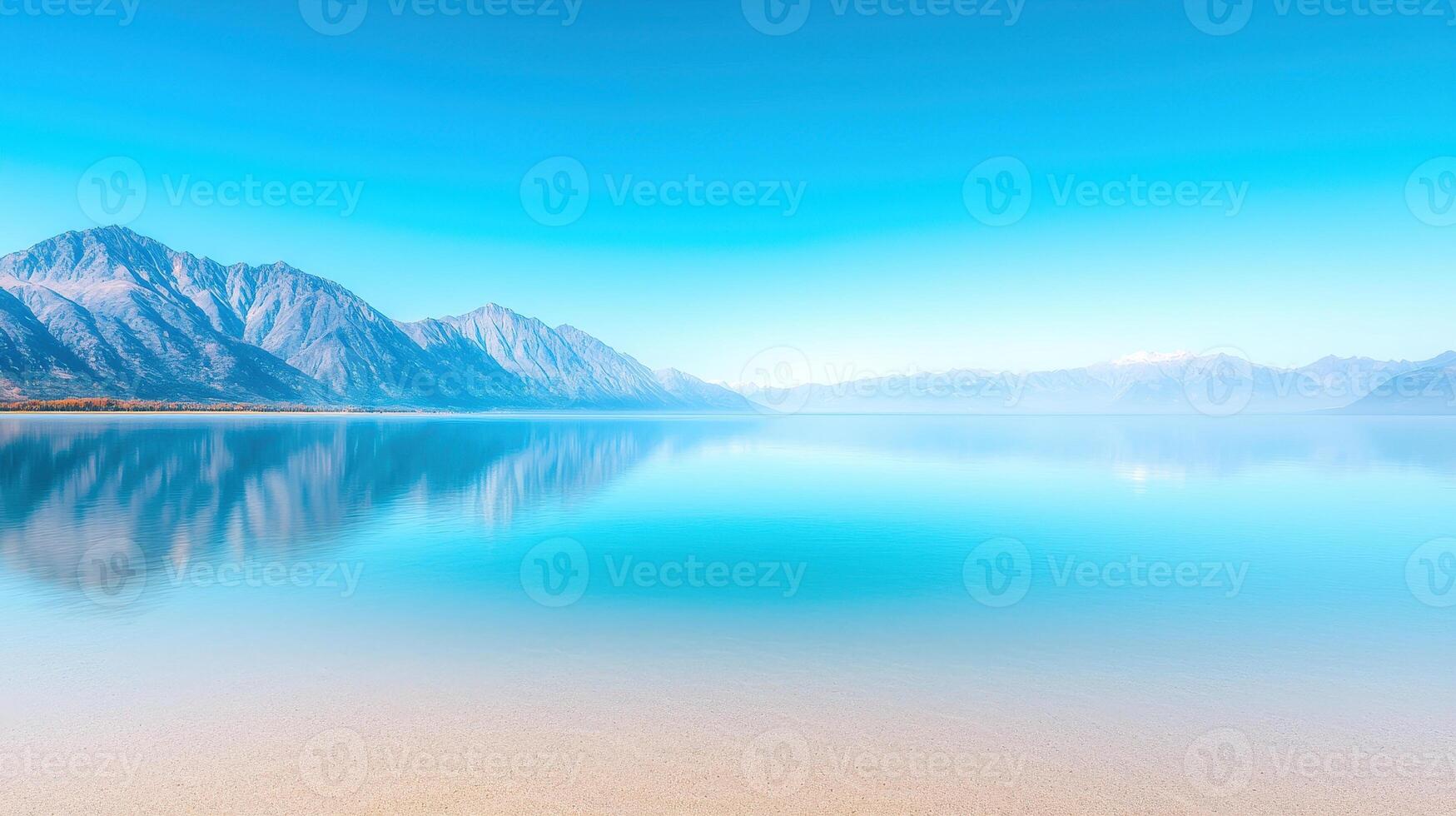serene lake reflects majestic mountains under clear blue sky, creating tranquil and peaceful atmosphere. calm water enhances beauty of landscape, inviting relaxation and contemplation photo