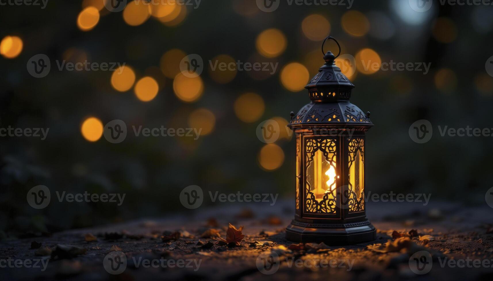 A lantern lit up on a wooden table photo