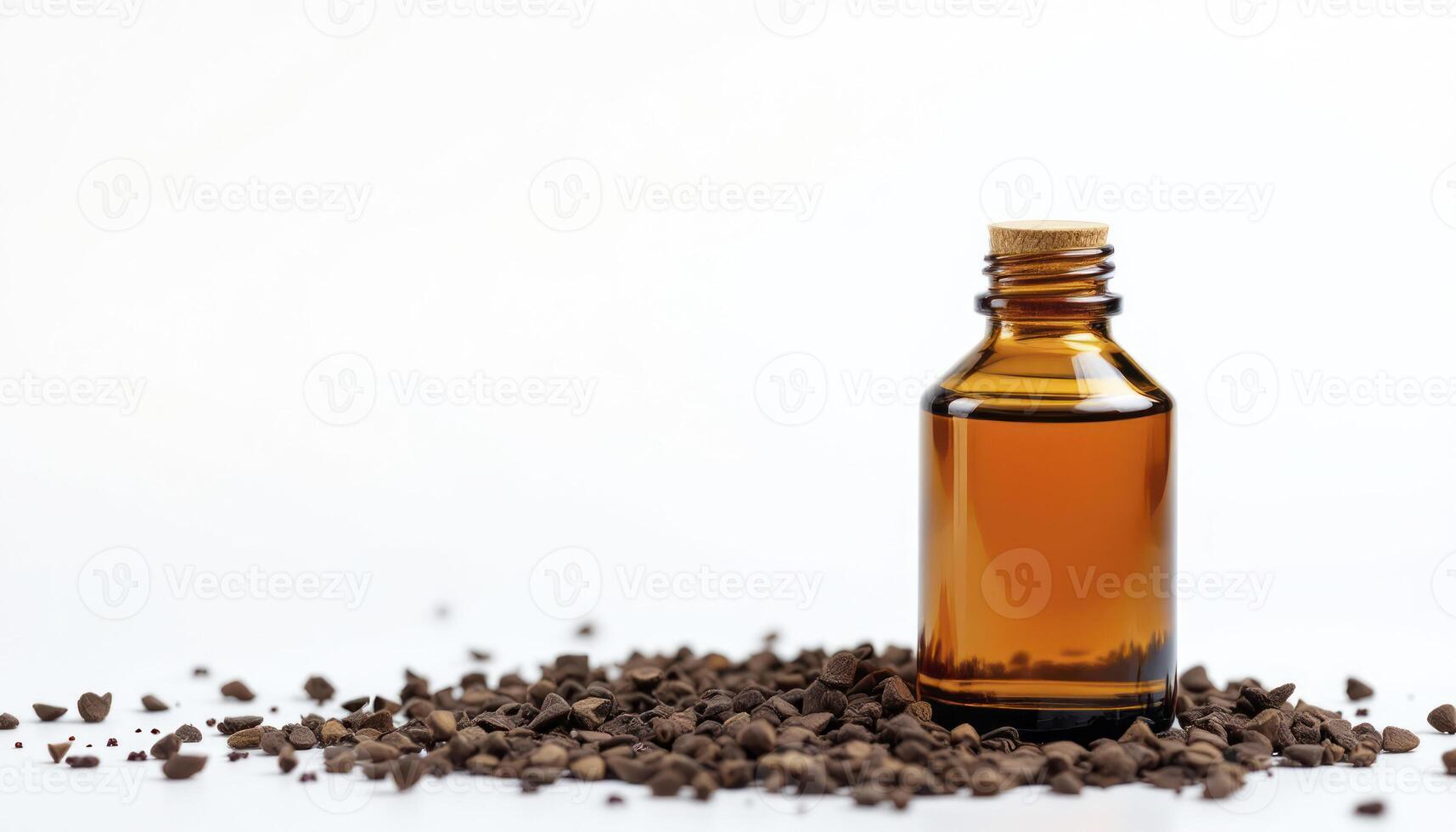 A bottle of essential oil and a pile of coffee beans photo