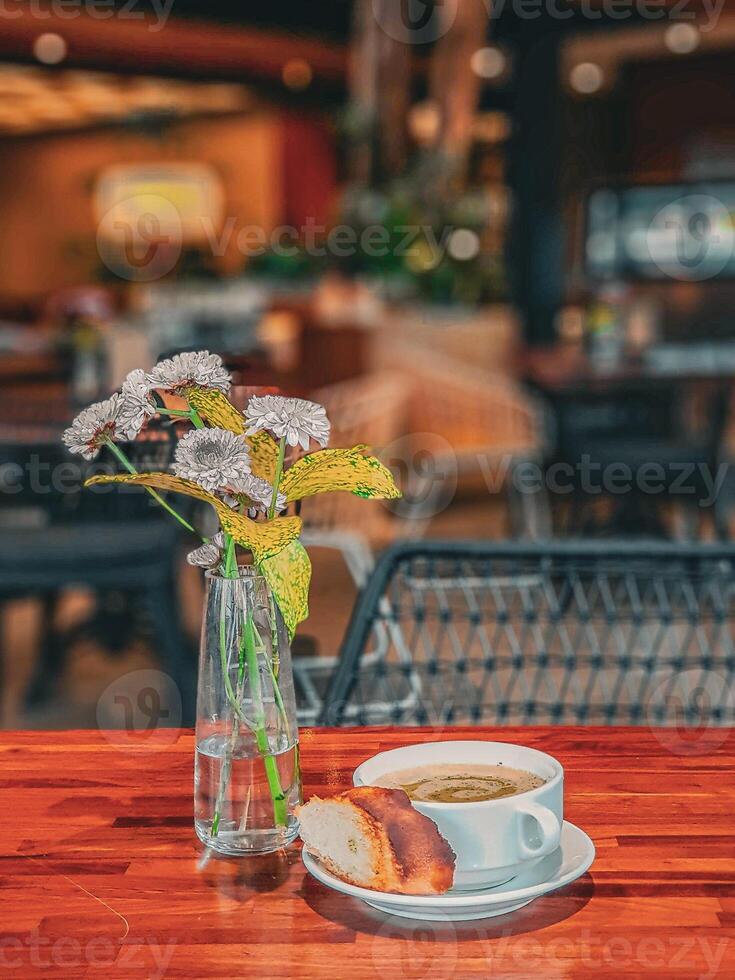Coffee and bread on a wooden table in a restaurant photo
