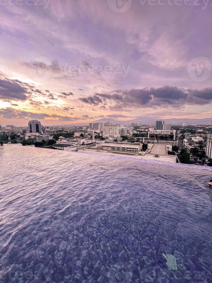 A view of the city from the infinity pool at sunset photo