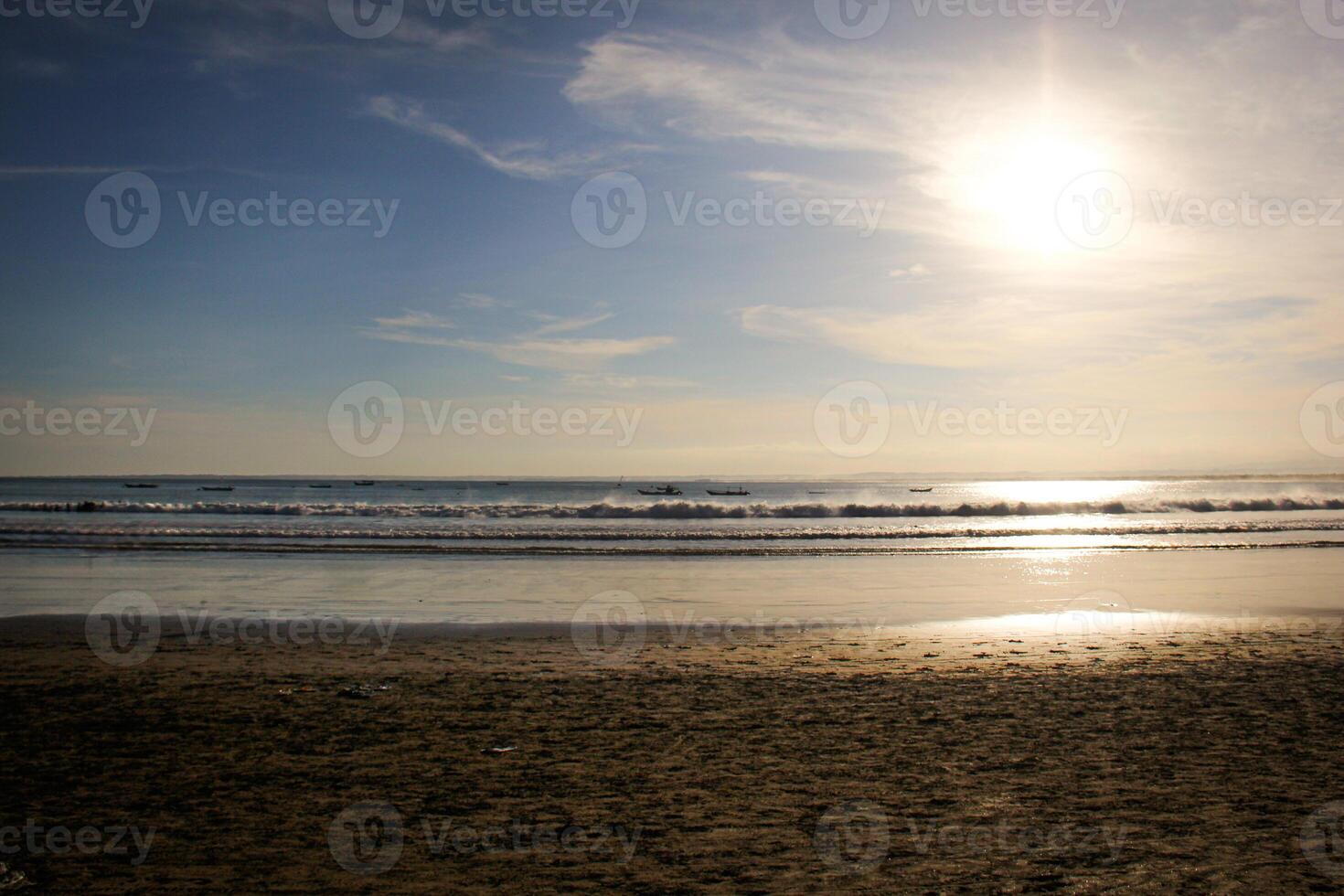 A person standing on a beach with a surfboard photo