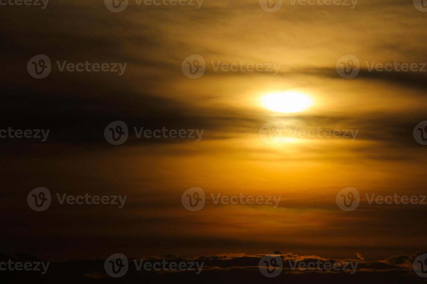 A plane flying in the sky at sunset photo