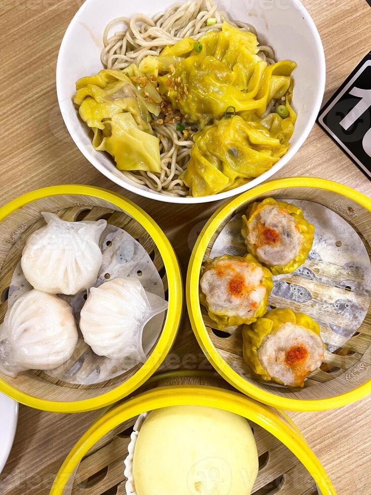 A table with four bowls of food photo