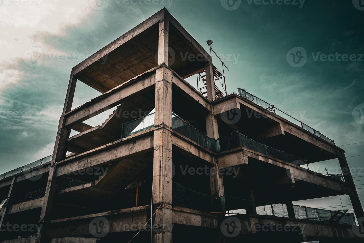 Abandoned concrete structure under a cloudy sky photo