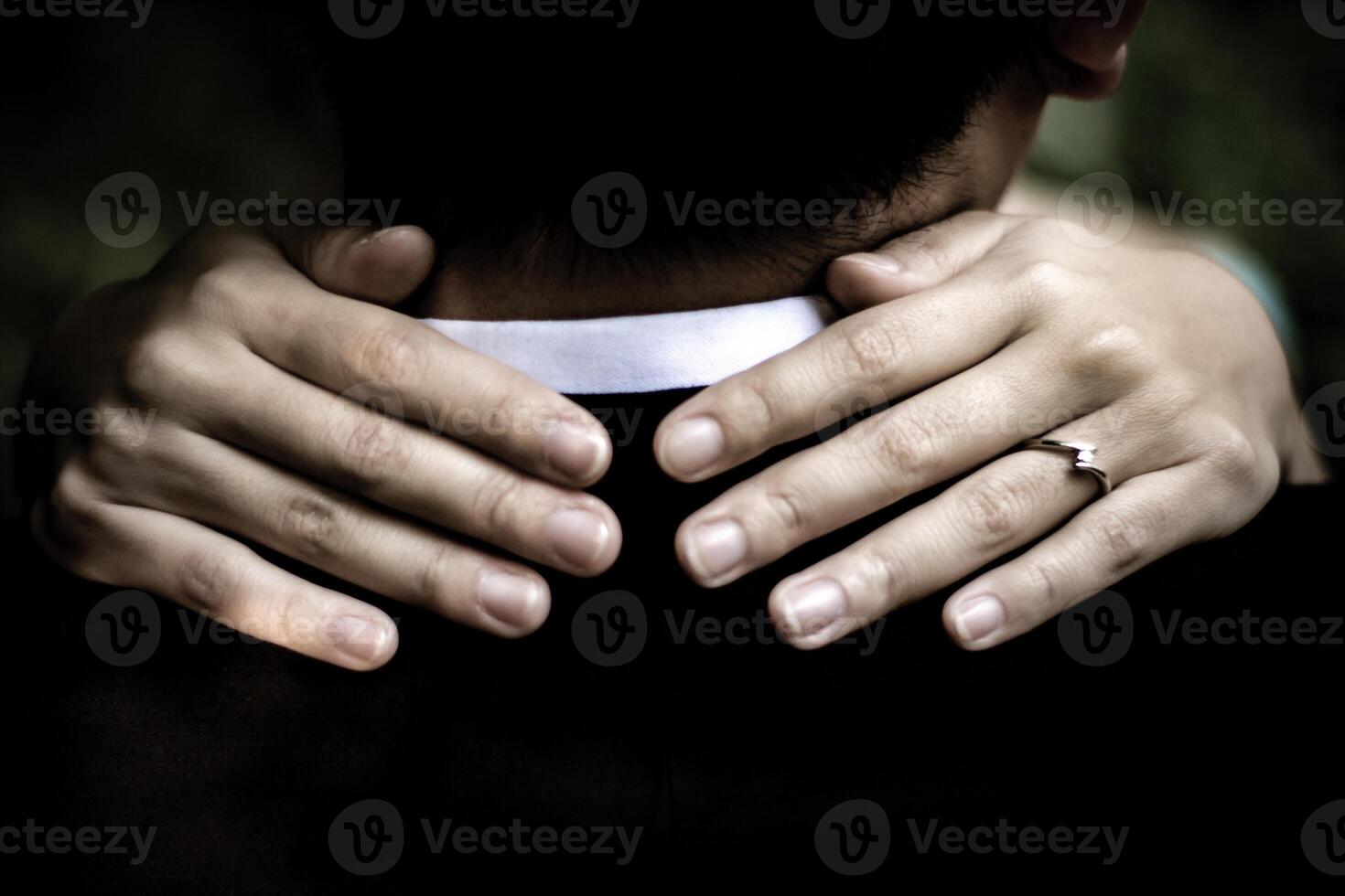 Romantic embrace with hands and a ring, a symbol of love and connection photo