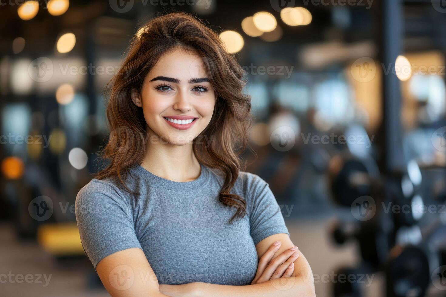 Smiling woman in gym during workout session with weights and fitness equipment in background photo