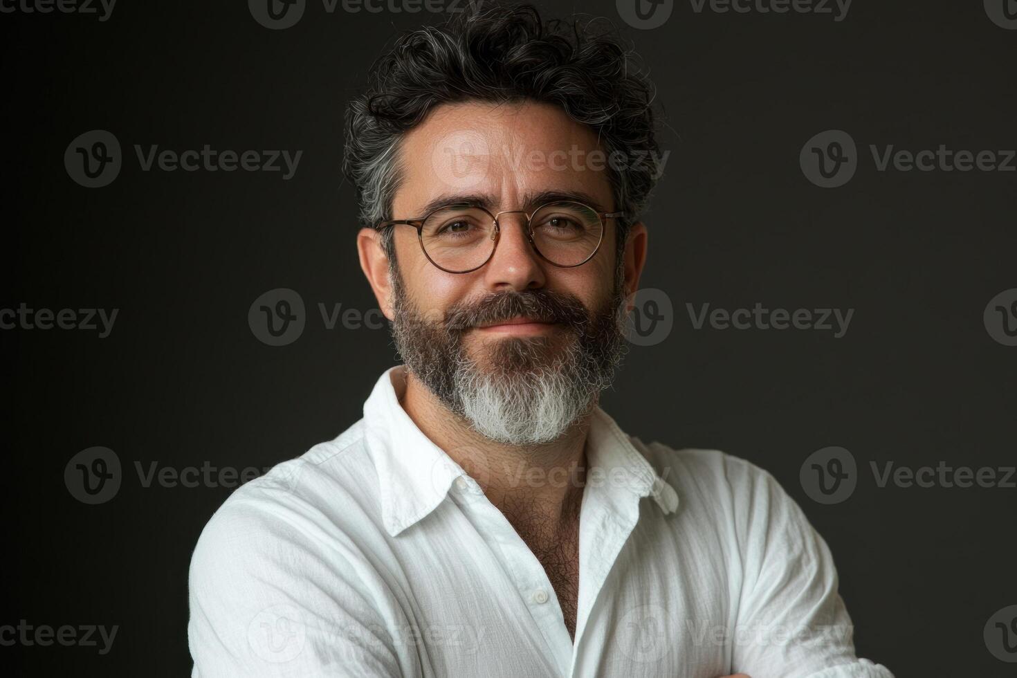 Professional man with glasses smiling confidently against a neutral background photo