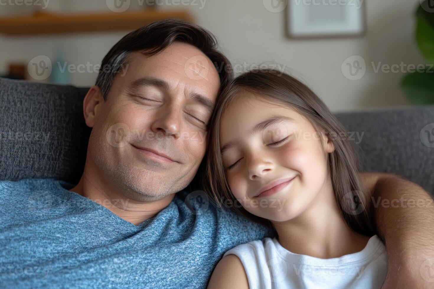 Father and daughter share a joyful moment while relaxing on the couch at home photo