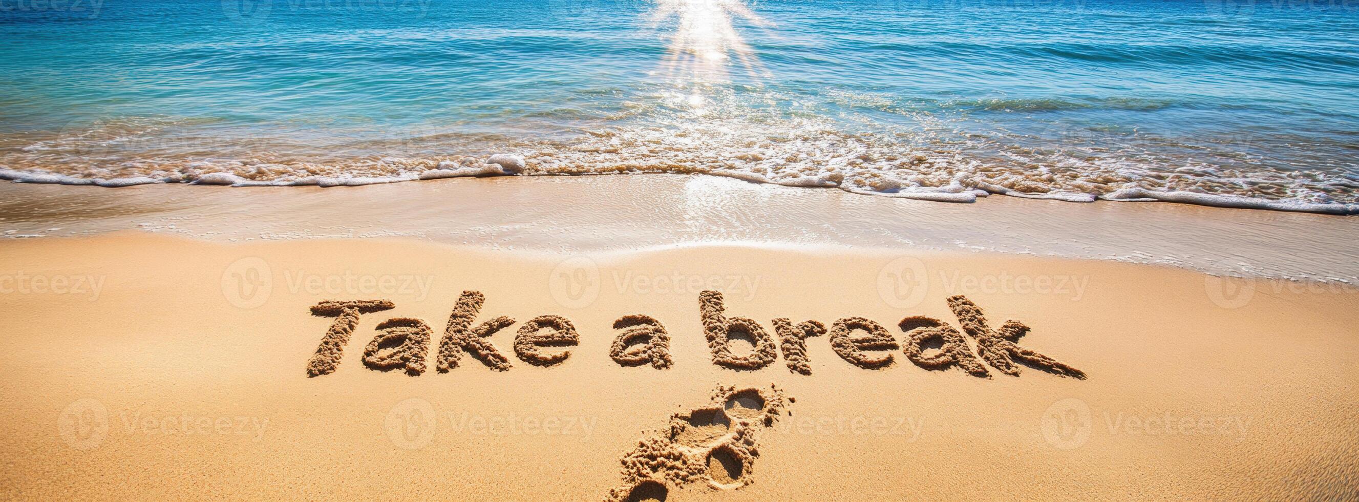 Footprints are leading to the words take a break written in the sand of a beautiful tropical beach with ocean waves and sun photo