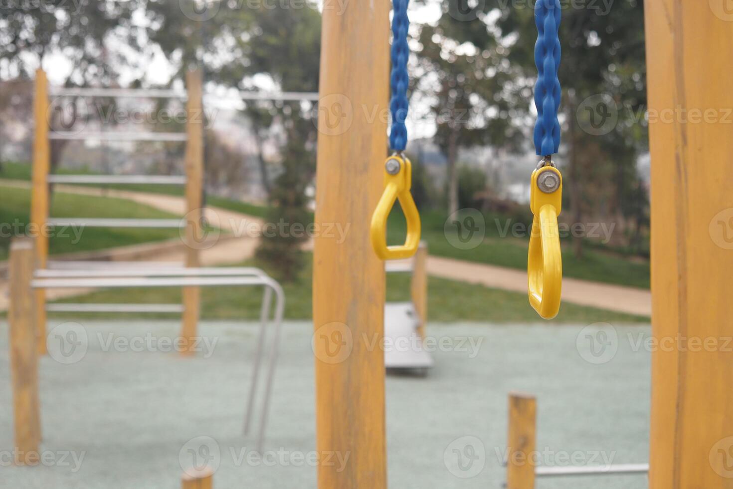 Playground swings and climbing structure in a park during daytime photo
