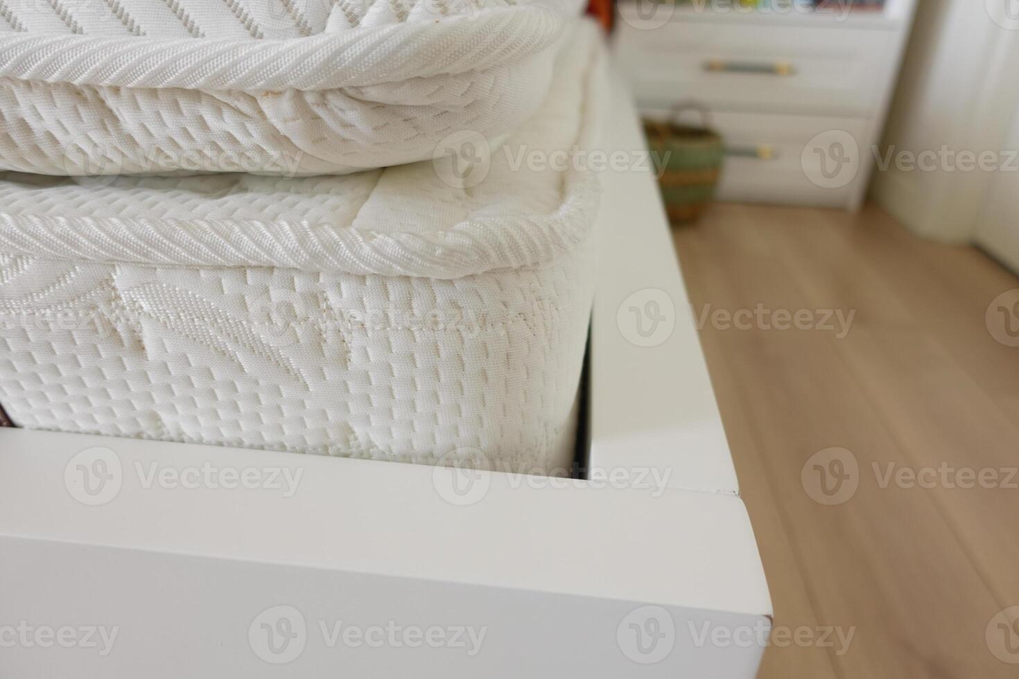 Comfortable white bedding neatly arranged on a modern bed frame photo