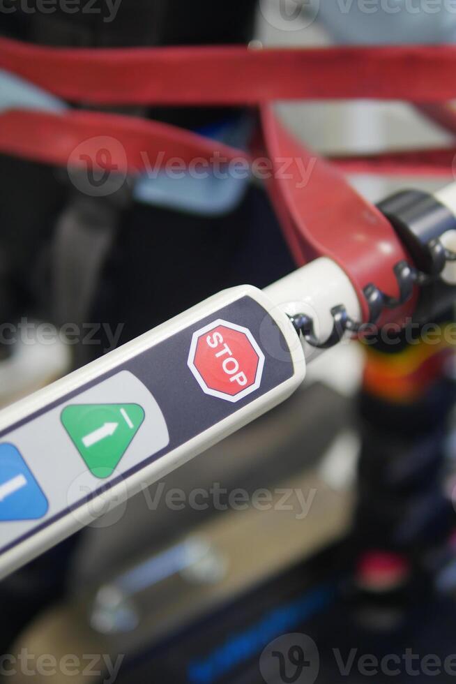 Control panel of a mobility device showing stop button and icons photo